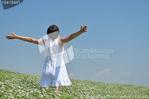 Image of Young happy woman in green field