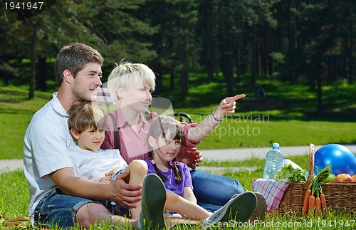 Image of Happy family playing together in a picnic outdoors
