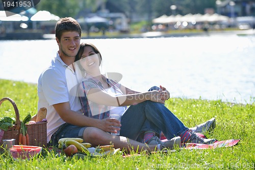 Image of happy young couple having a picnic outdoor