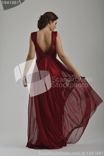 Image of elegant woman in fashionable dress posing in the studio