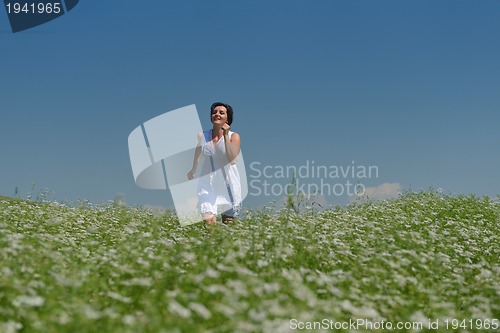 Image of Young happy woman in green field