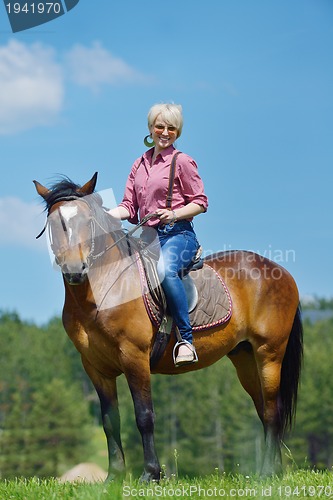 Image of happy woman  on  horse