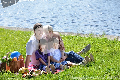 Image of Happy family playing together in a picnic outdoors