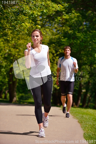 Image of Young couple jogging