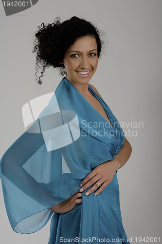 Image of elegant woman in fashionable dress posing in the studio