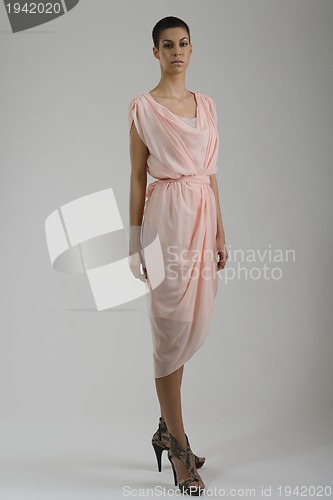 Image of elegant woman in fashionable dress posing in the studio