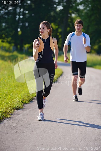 Image of Young couple jogging