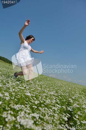 Image of Young happy woman in green field