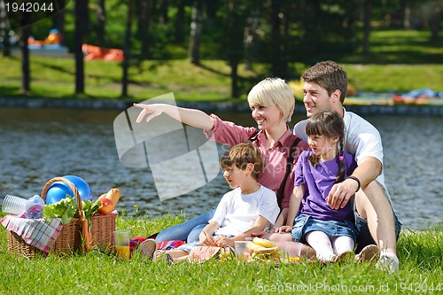 Image of Happy family playing together in a picnic outdoors