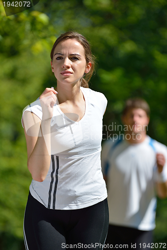Image of Young couple jogging at morning