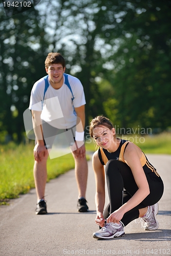 Image of Couple doing stretching exercise  after jogging