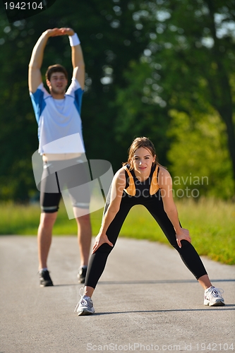 Image of Couple doing stretching exercise  after jogging