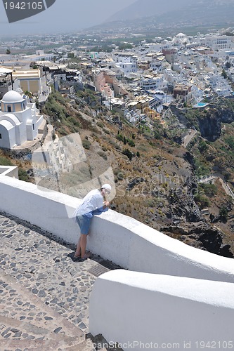 Image of Greek woman on the streets of Oia, Santorini, Greece