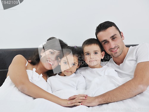 Image of happy young Family in their bedroom