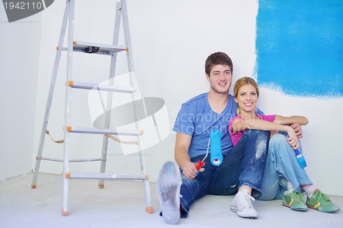 Image of happy young cople relaxing after painting in new home