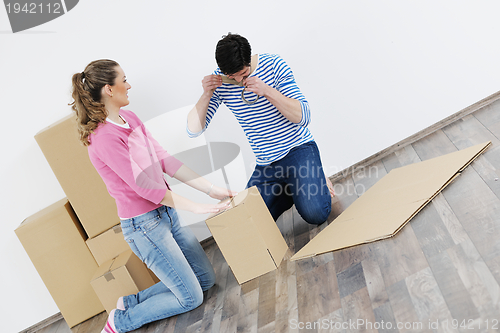 Image of Young couple moving in new home