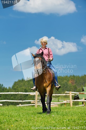 Image of happy woman  on  horse