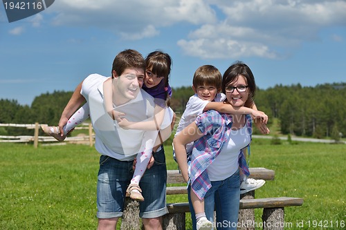 Image of happy young family have fun outdoors