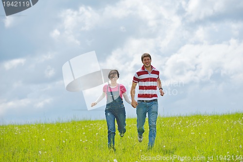 Image of Portrait of romantic young couple smiling together outdoor
