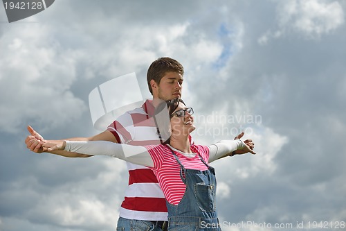 Image of Portrait of romantic young couple smiling together outdoor