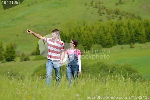 Image of Portrait of romantic young couple smiling together outdoor