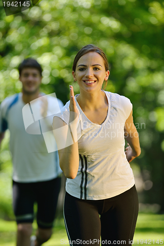 Image of Young couple jogging at morning