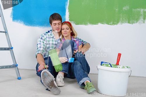 Image of happy young cople relaxing after painting in new home