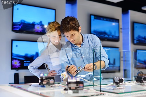 Image of Young couple in consumer electronics store