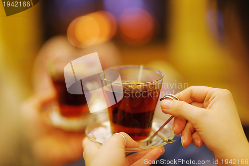 Image of Young romantic couple relax on sofa in front of fireplace at hom