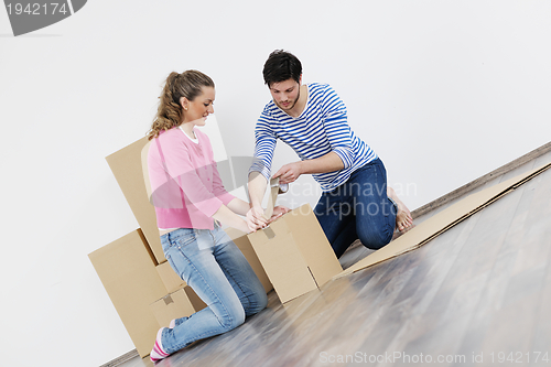 Image of Young couple moving in new home