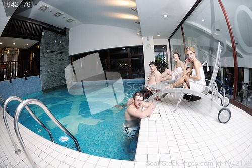 Image of young people group at spa swimming pool