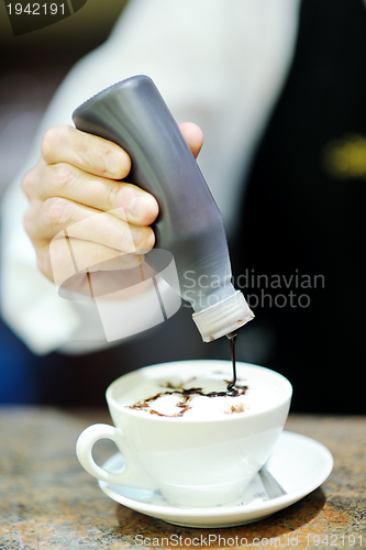 Image of Barista prepares cappuccino