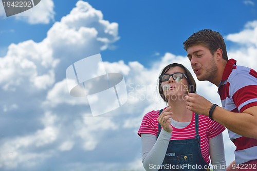 Image of Portrait of romantic young couple smiling together outdoor