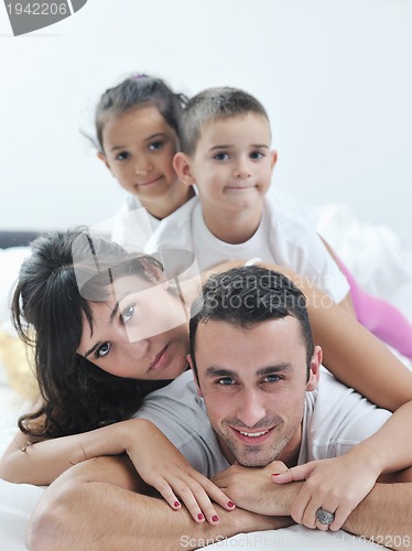 Image of happy young Family in their bedroom