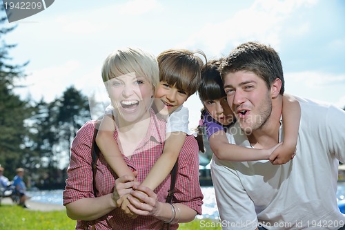 Image of happy young family have fun outdoors