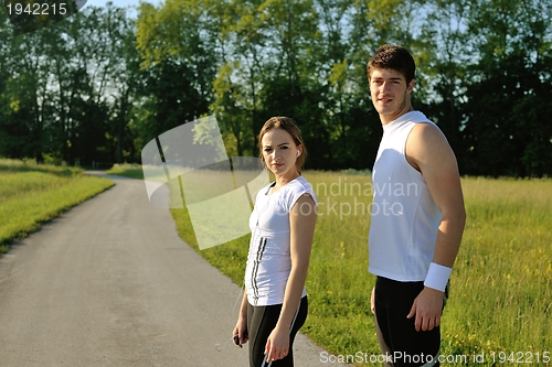 Image of Couple doing stretching exercise  after jogging