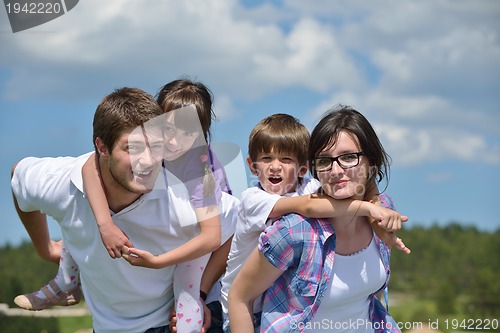 Image of happy young family have fun outdoors