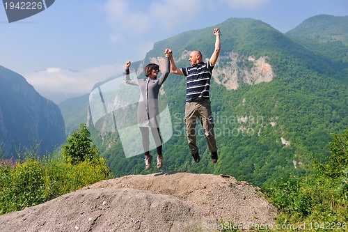 Image of happy young couple jumping in the air