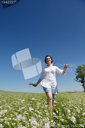 Image of Young happy woman in green field