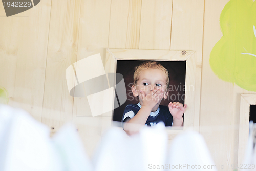 Image of happy child in a window