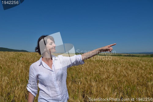 Image of young woman in wheat field at summer