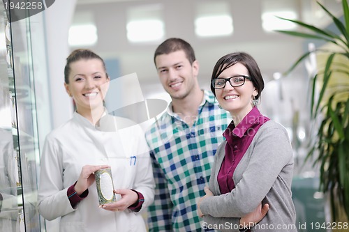 Image of pharmacist suggesting medical drug to buyer in pharmacy drugstor