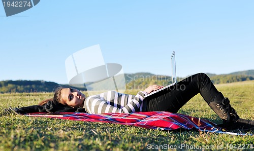 Image of young teen girl work on laptop outdoor