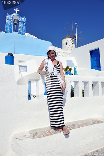 Image of Greek woman on the streets of Oia, Santorini, Greece