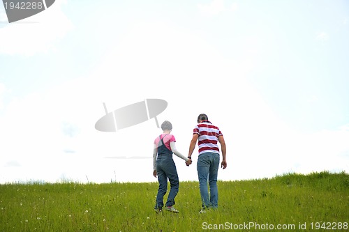 Image of Portrait of romantic young couple smiling together outdoor