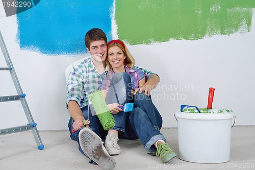 Image of happy young cople relaxing after painting in new home