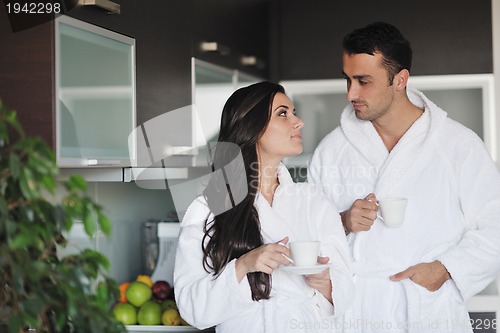 Image of Young love couple taking fresh morning cup of coffee