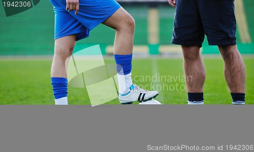 Image of football players in competition for the ball