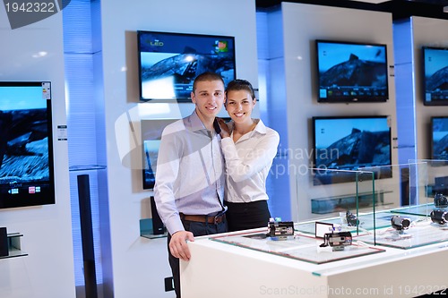 Image of Young couple in consumer electronics store