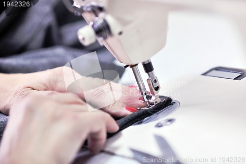 Image of Hands of Seamstress Using Sewing Machine